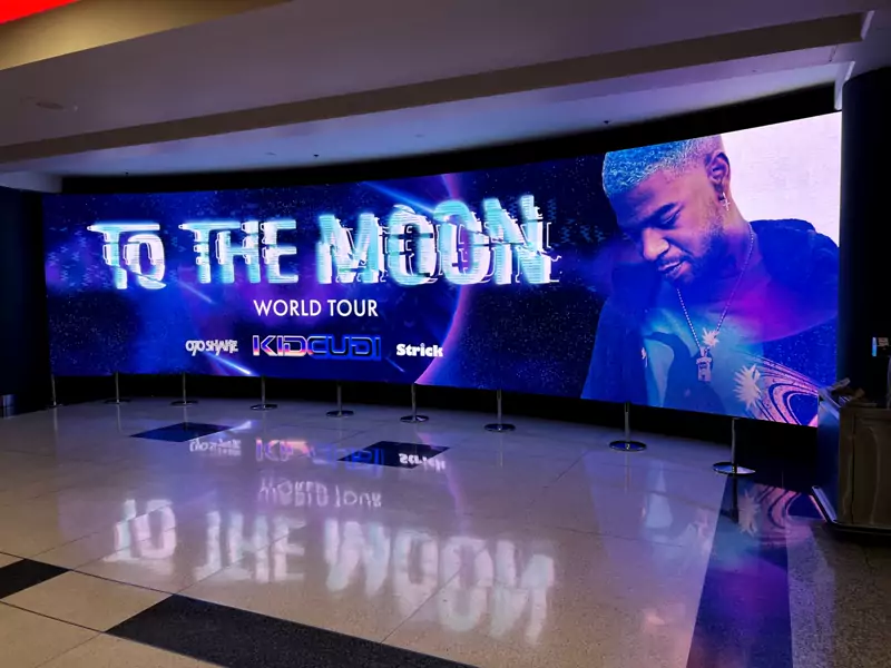 Large LED video wall on a stage, reflected in a glossy floor